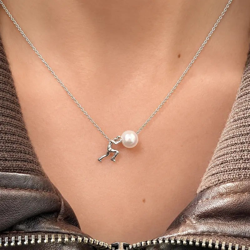 Figure Holding Pearl Necklace