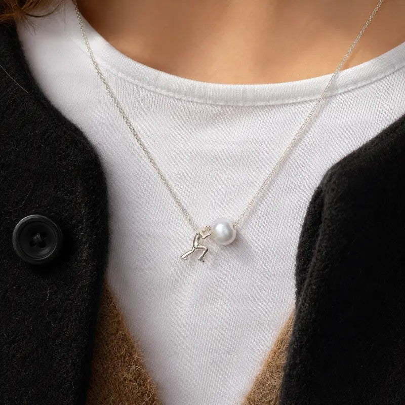 Figure Holding Pearl Necklace